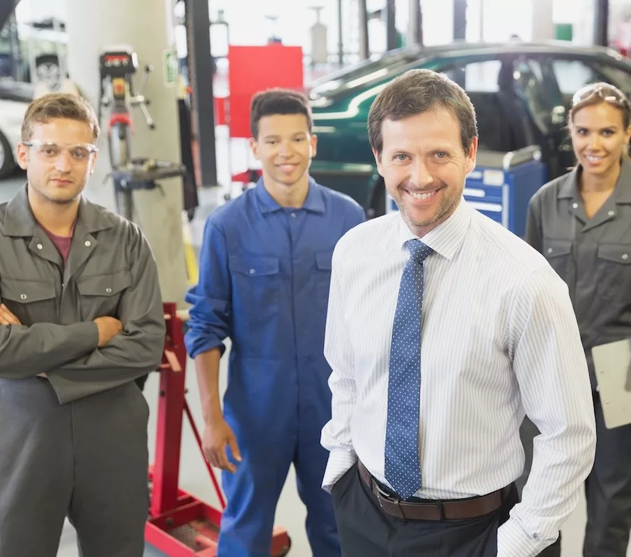 Excited employees after receiving their automotive employee certifications